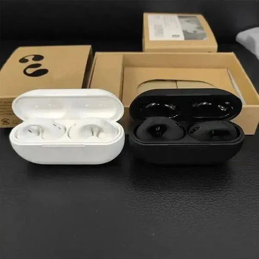 White and black wireless earbuds in open charging cases with cardboard boxes in the background