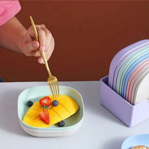 Sunehri Store plastic pastel plate set with fruit, hand holding fork, kitchen table scene