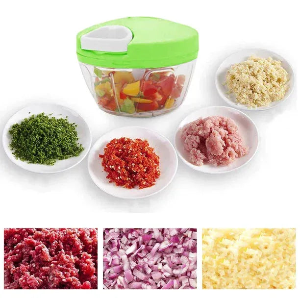Manual food chopper with green lid and chopped herbs, red peppers, minced meat, and garlic on plates