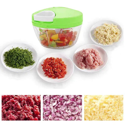 Manual food chopper with green lid and chopped herbs, red peppers, minced meat, and garlic on plates